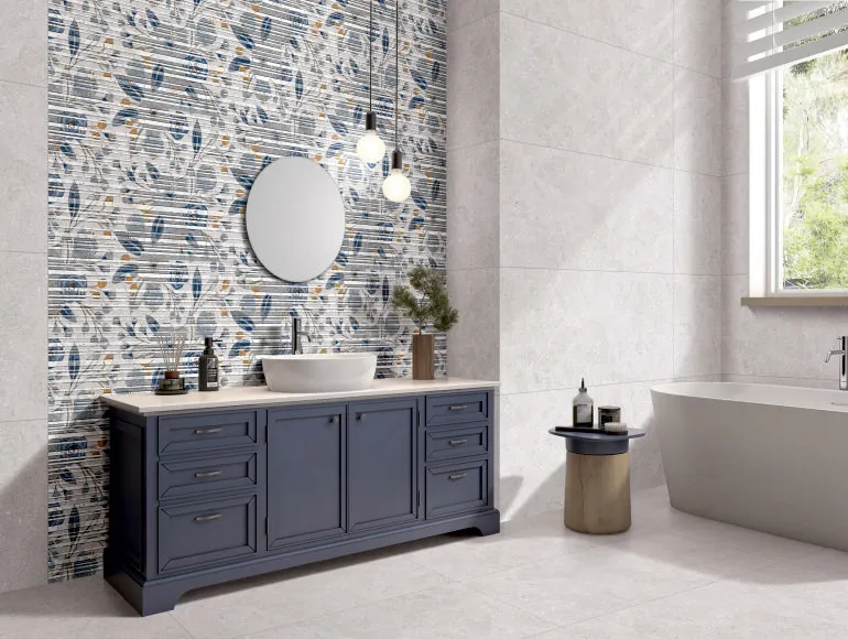 Modern grey bathroom design featuring a sink with cabinets, round mirror and window